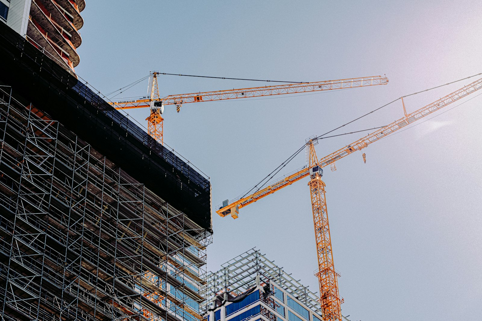 Residential tower under construction with a crane in the foreground
